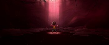 Movie still from “My Father's Dragon” (2022), directed by Nora Twomey – A boy standing in front of a light in a cave; Extreme Wide shot, Low angle