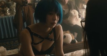 Movie still from “The Forest of Love” (2019), directed by Sion Sono – A woman with blue hair sitting in front of a mirror; Close Up shot, Over the shoulder angle