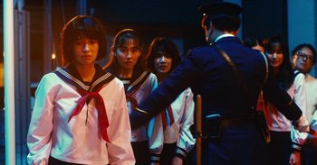 Movie still from “The Forest of Love” (2019), directed by Sion Sono – A group of young people standing next to each other; Medium shot, Low angle