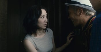 Movie still from “The Forest of Love” (2019), directed by Sion Sono – A woman and a man talking to each other; Close Up shot, Over the shoulder angle