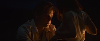 Movie still from “The Glass Castle” (2017), directed by Destin Daniel Cretton – A man sitting in front of a woman in a dark room; Close Up shot, Over the shoulder angle