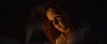 Movie still from “The Glass Castle” (2017), directed by Destin Daniel Cretton – A little girl with long red hair is looking at the camera; Close Up shot, Over the shoulder angle