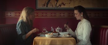 Movie still from “The Glass Castle” (2017), directed by Destin Daniel Cretton – Two people sitting at a table with plates of food and chopsticks in front of them; Medium shot, High angle