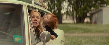 Movie still from “The Glass Castle” (2017), directed by Destin Daniel Cretton – A woman and a child in the back of a car; Medium shot, Low angle