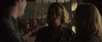 Movie still from “The Glass Castle” (2017), directed by Destin Daniel Cretton – A young woman is holding a piece of food; Close Up shot, Over the shoulder angle