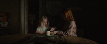 Movie still from “The Glass Castle” (2017), directed by Destin Daniel Cretton – A woman and a child sitting at a table; Medium shot, Low angle