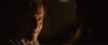 Movie still from “The Glass Castle” (2017), directed by Destin Daniel Cretton – A man's face in a dark room; Close Up shot, Over the shoulder angle