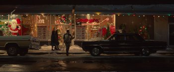 Movie still from “The Glass Castle” (2017), directed by Destin Daniel Cretton – A man walking down the street in front of a store; Extreme Wide shot, Over the shoulder angle