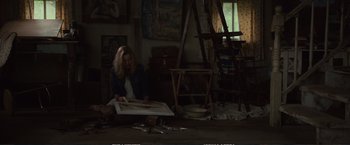 Movie still from “The Glass Castle” (2017), directed by Destin Daniel Cretton – A woman sitting on the ground in a room; Wide shot, High angle