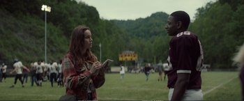 Movie still from “The Glass Castle” (2017), directed by Destin Daniel Cretton – Two people standing in a field talking to each other; Medium shot, Over the shoulder angle