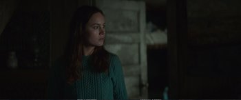 Movie still from “The Glass Castle” (2017), directed by Destin Daniel Cretton – A woman wearing a green sweater looking to her left; Medium shot, Over the shoulder angle