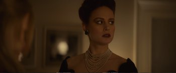Movie still from “The Glass Castle” (2017), directed by Destin Daniel Cretton – A woman wearing pearls and a black dress; Close Up shot, Over the shoulder angle
