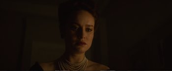 Movie still from “The Glass Castle” (2017), directed by Destin Daniel Cretton – A woman in a dark room wearing pearls and wearing a necklace; Close Up shot, Low angle