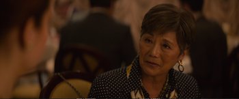 Movie still from “The Glass Castle” (2017), directed by Destin Daniel Cretton – An older woman sitting in front of an audience; Close Up shot, Over the shoulder angle