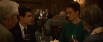 Movie still from “The Glass Castle” (2017), directed by Destin Daniel Cretton – A man and a woman sitting at a dinner table; Medium shot, Over the shoulder angle