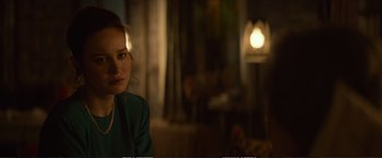 Movie still from “The Glass Castle” (2017), directed by Destin Daniel Cretton – A woman sitting in front of a lamp in a dark room; Close Up shot, Over the shoulder angle