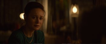 Movie still from “The Glass Castle” (2017), directed by Destin Daniel Cretton – A woman sitting in front of a window looking sad; Close Up shot, Over the shoulder angle