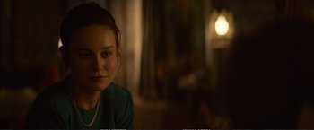 Movie still from “The Glass Castle” (2017), directed by Destin Daniel Cretton – A young woman sitting in front of a window; Close Up shot, Over the shoulder angle