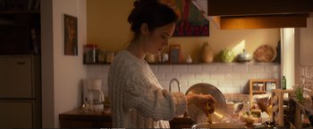 Movie still from “The Glass Castle” (2017), directed by Destin Daniel Cretton – A woman in a kitchen preparing food in a pan; Medium shot, Over the shoulder angle
