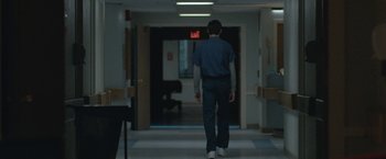 Movie still from “The Good Nurse” (2022), directed by Tobias Lindholm – A man walking down a hallway in a hospital; Wide shot, Low angle