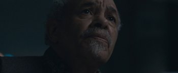 Movie still from “The Good Nurse” (2022), directed by Tobias Lindholm – An older man with a beard and mustache looking up; Close Up shot, Low angle