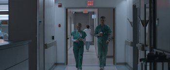 Movie still from “The Good Nurse” (2022), directed by Tobias Lindholm – Two doctors walking down a hallway in a hospital; Wide shot, Low angle