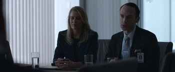 Movie still from “The Good Nurse” (2022), directed by Tobias Lindholm – A woman sitting at a table in front of two men; Medium shot, Over the shoulder angle