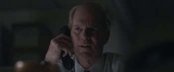 Movie still from “The Good Nurse” (2022), directed by Tobias Lindholm – An older man talking on a phone in the dark; Close Up shot, Low angle