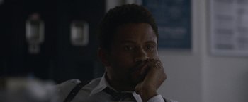 Movie still from “The Good Nurse” (2022), directed by Tobias Lindholm – A person with his hand on his face; Close Up shot, High angle