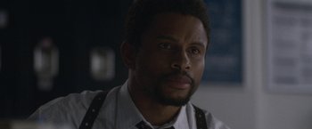 Movie still from “The Good Nurse” (2022), directed by Tobias Lindholm – A person wearing a shirt and tie; Close Up shot, Over the shoulder angle