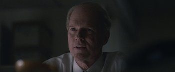 Movie still from “The Good Nurse” (2022), directed by Tobias Lindholm – An older man wearing a white shirt and a tie; Close Up shot, Over the shoulder angle