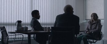 Movie still from “The Good Nurse” (2022), directed by Tobias Lindholm – Two men sitting at a table in front of each other; Wide shot, Over the shoulder angle
