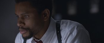 Movie still from “The Good Nurse” (2022), directed by Tobias Lindholm – A person wearing a shirt and a tie; Close Up shot, Over the shoulder angle