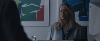 Movie still from “The Good Nurse” (2022), directed by Tobias Lindholm – A woman in a gray jacket is looking at the camera; Close Up shot, Over the shoulder angle