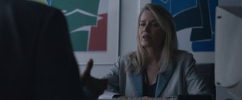 Movie still from “The Good Nurse” (2022), directed by Tobias Lindholm – A woman sitting at a table talking to someone; Medium shot, Over the shoulder angle