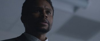 Movie still from “The Good Nurse” (2022), directed by Tobias Lindholm – A person wearing a white shirt; Close Up shot, Low angle