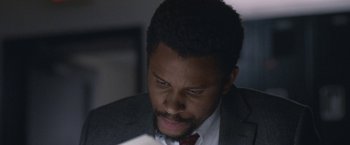 Movie still from “The Good Nurse” (2022), directed by Tobias Lindholm – A person wearing a suit and tie; Close Up shot, Low angle