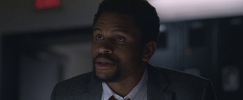 Movie still from “The Good Nurse” (2022), directed by Tobias Lindholm – A person wearing a suit and tie; Close Up shot, Low angle