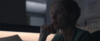 Movie still from “The Good Nurse” (2022), directed by Tobias Lindholm – A person with her hand on her chin; Close Up shot, Over the shoulder angle