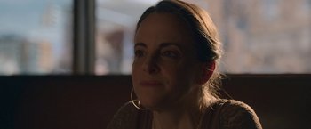 Movie still from “The Good Nurse” (2022), directed by Tobias Lindholm – A person wearing a brown shirt; Close Up shot, Over the shoulder angle