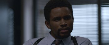 Movie still from “The Good Nurse” (2022), directed by Tobias Lindholm – A person wearing a suit and tie; Close Up shot, Over the shoulder angle