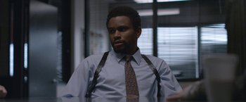 Movie still from “The Good Nurse” (2022), directed by Tobias Lindholm – A man wearing a tie and a shirt; Medium shot, Over the shoulder angle