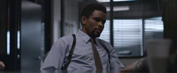 Movie still from “The Good Nurse” (2022), directed by Tobias Lindholm – A man in a dress shirt , tie , and suspenders; Medium shot, Over the shoulder angle