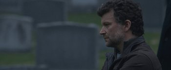 Movie still from “The Good Nurse” (2022), directed by Tobias Lindholm – A person looking to his left; Close Up shot, Over the shoulder angle