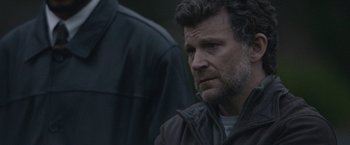 Movie still from “The Good Nurse” (2022), directed by Tobias Lindholm – A person wearing a jacket; Close Up shot, Over the shoulder angle