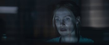 Movie still from “The Good Nurse” (2022), directed by Tobias Lindholm – A woman looking at the camera in a dimly - lit room; Close Up shot, Low angle