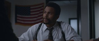 Movie still from “The Good Nurse” (2022), directed by Tobias Lindholm – A man wearing a tie and suspenders looks to his left; Close Up shot, Low angle