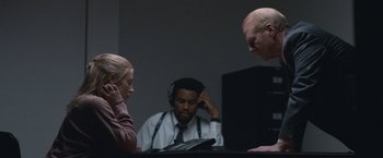 Movie still from “The Good Nurse” (2022), directed by Tobias Lindholm – A man and two women sitting in front of a tablet; Medium shot, Over the shoulder angle