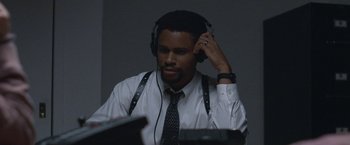 Movie still from “The Good Nurse” (2022), directed by Tobias Lindholm – A man wearing headphones and a white dress shirt; Close Up shot, High angle
