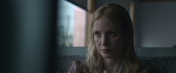 Movie still from “The Good Nurse” (2022), directed by Tobias Lindholm – A person sitting on a couch; Close Up shot, Over the shoulder angle